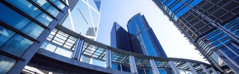 An image of a footbridge and modern office buildings