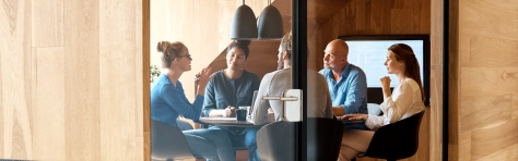 People sat round a boardroom table in discussion
