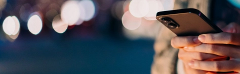 Hands operating an iPhone